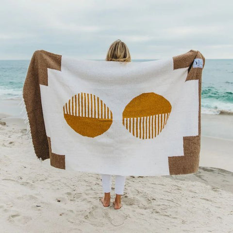 blanket at beach with woman