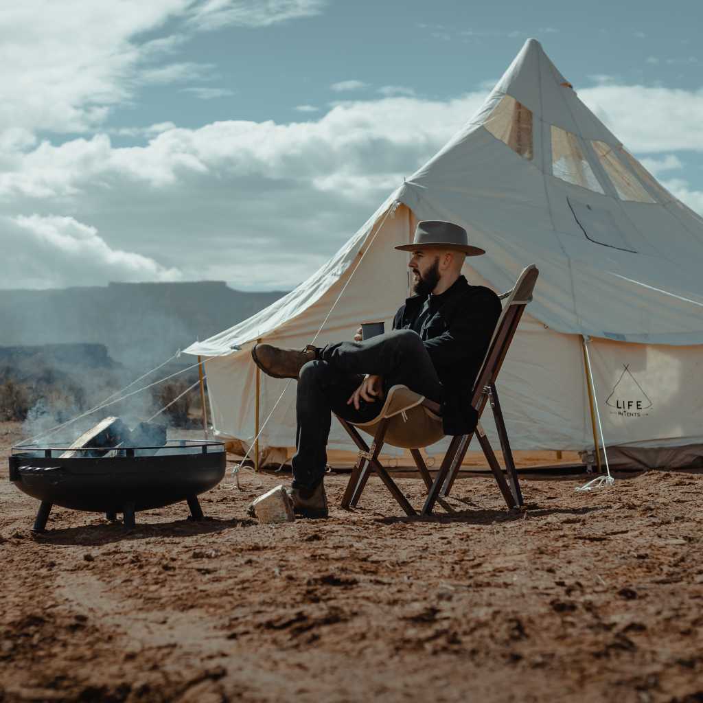 canvas tent near campfire in desert