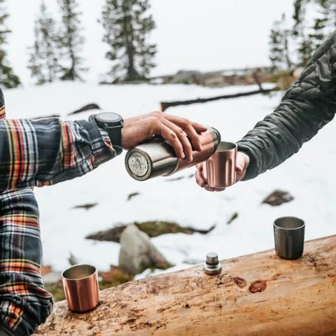 camping flask in snow